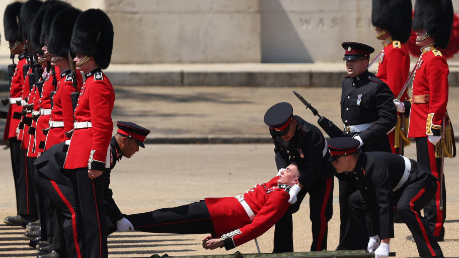 A member of the Grenadier Guards is carried after fainting during the Colonel's Review at Horse Guards Parade in London on June 10, 2023 ahead of The King's Birthday Parade.