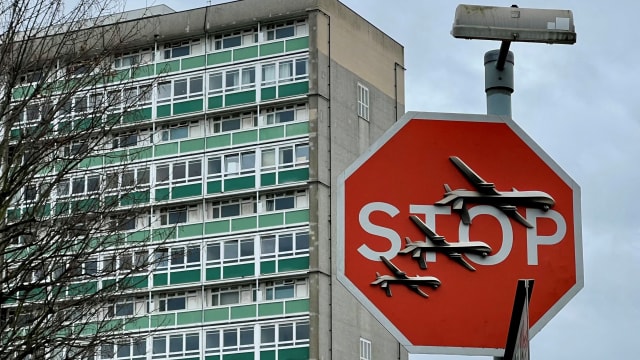 Banksy artwork depicting drones covers a stop sign in London