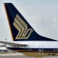 A Singapore Airlines planes sit on the tarmac.