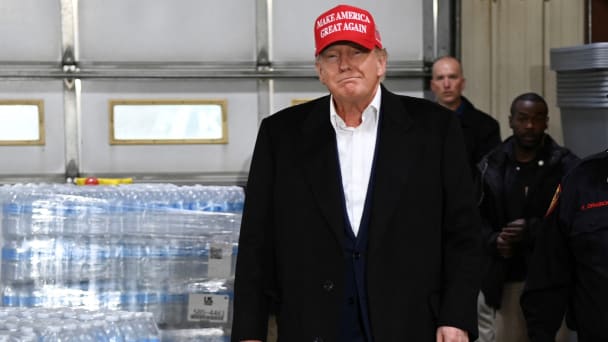 Donald Trump walks past pallets of donated water bottles with a “Trump” label during an event at a fire station to speak about the recent derailment of a train carrying hazardous waste, in East Palestine, Ohio, U.S., February 22, 2023. 