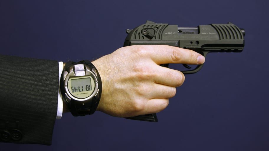 A man holds a prototype of a smart gun by Armatix during  the International Guns Exhibition 'IWA & OutdoorClassics' in Nuremberg March  13, 2009. 