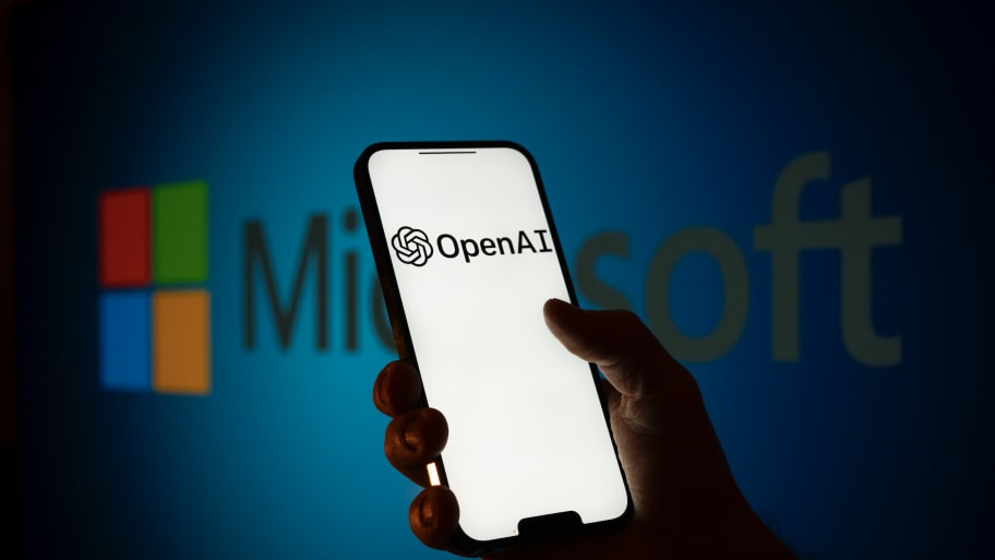 The Microsoft and OpenAI logos are seen on screens in this illustration photo.