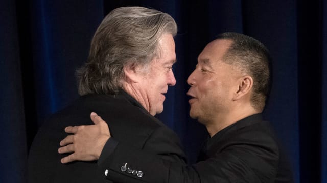 Former White House Chief Strategist Steve Bannon (L) greets Chinese billionaire Guo Wengui