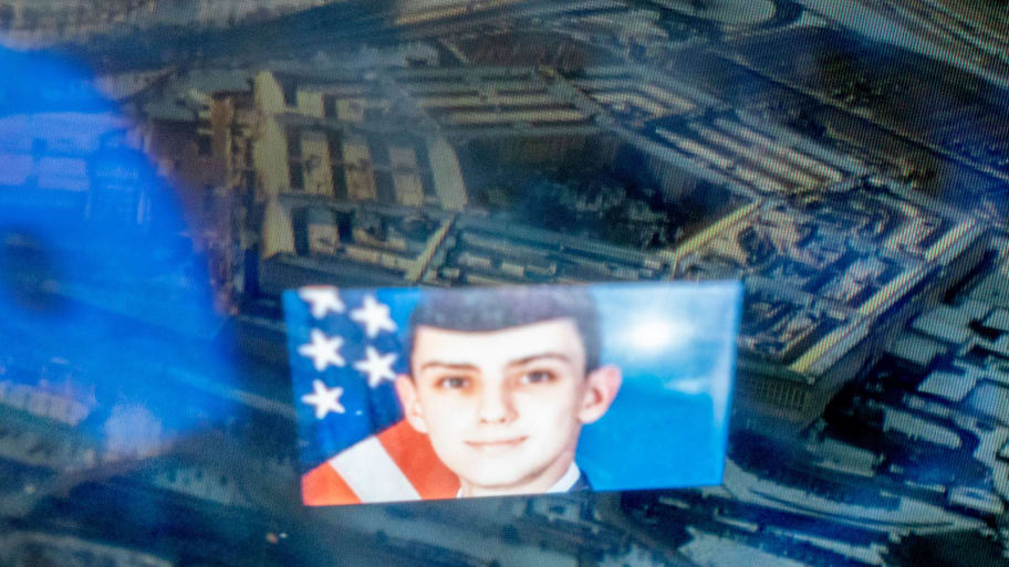 This photo illustration created on April 13, 2023, shows the Discord logo and the suspect, national guardsman Jack Teixeira, reflected in an image of the Pentagon in Washington, DC