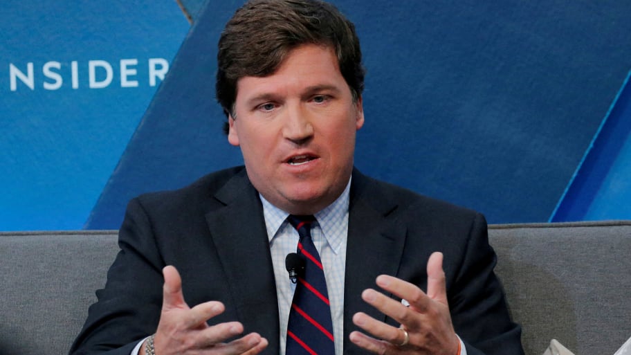 Tucker Carlson pictured speaking at an event.