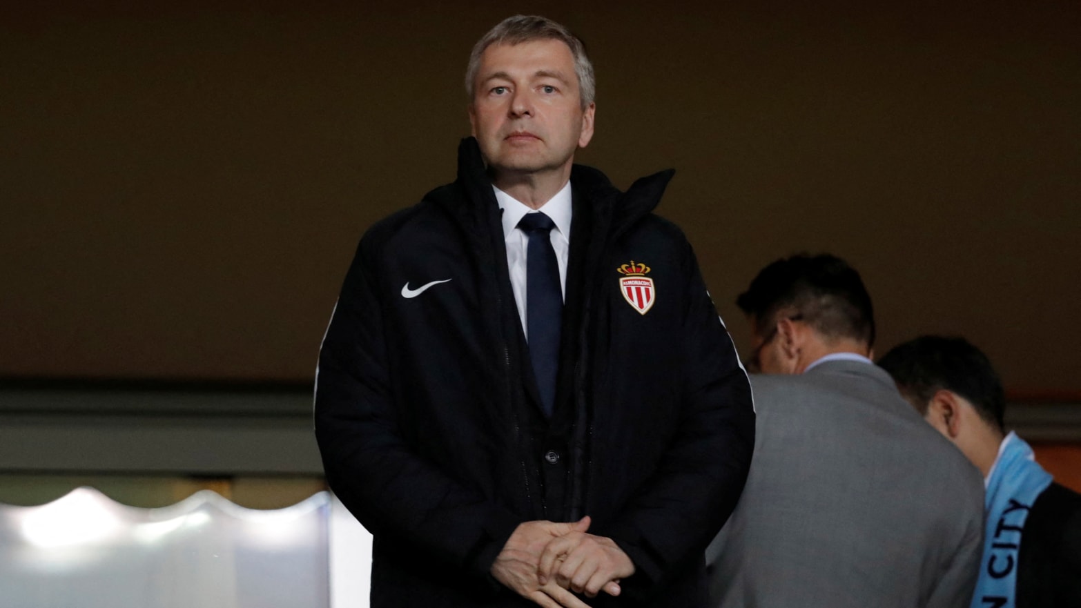 Dmitry Rybolovlev stands in a suite during a Champions League soccer match.