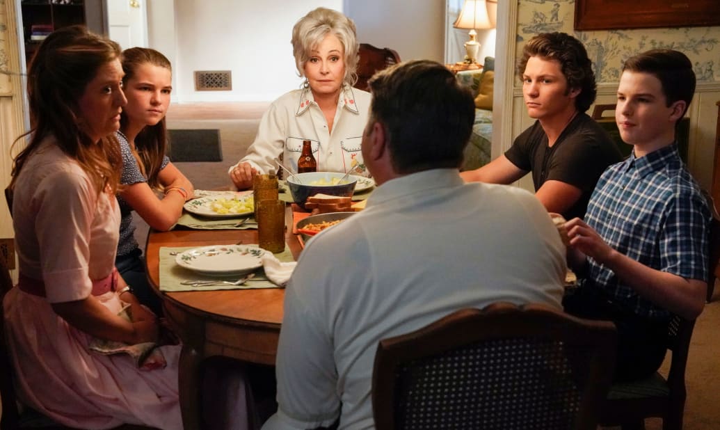 Annie Potts sits at the head of a dinner table in 'Young Sheldon'