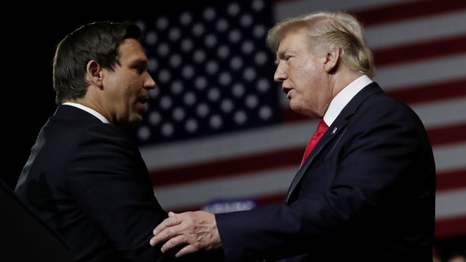 U.S. President Donald Trump talks with Republican Florida governor candidate Ron DeSantis during a Make America Great Again Rally at the Florida State Fairgrounds in Tampa, Florida, U.S., July 31, 2018.