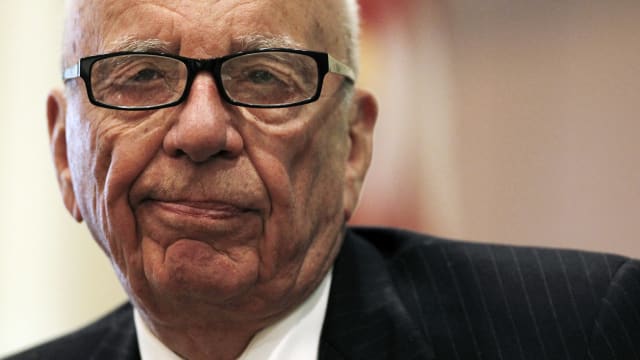 Rupert Murdoch smirks.
