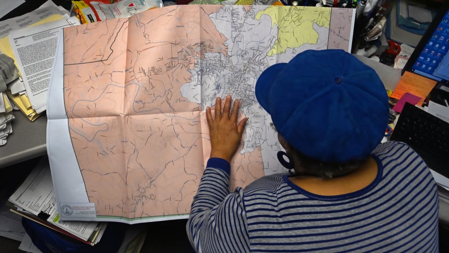 Vanessa Waddell sits at her office desk and double checks some redistricting maps that had just arrived by mail in Rome, Georgia.