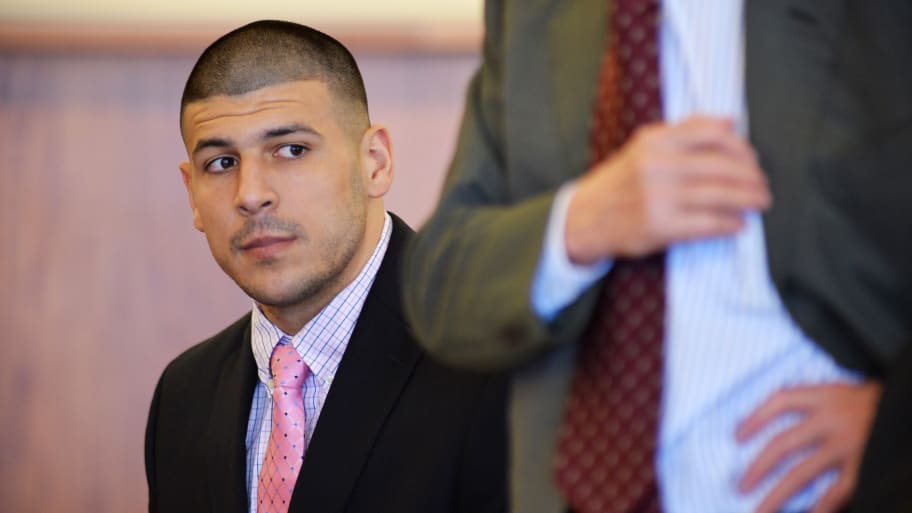 Aaron Hernandez sits in court next to a lawyer.