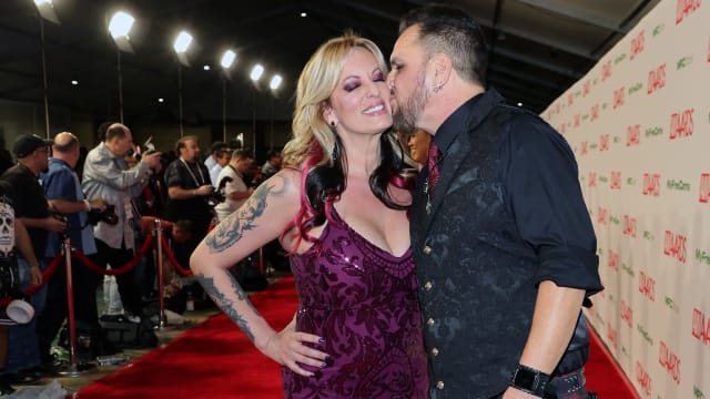 Adult film actress/director Stormy Daniels (L) is kissed by adult film actor/director Barrett Blade as they attend the 2023 Adult Video News Awards at Resorts World Las Vegas on January 07, 2023 in Las Vegas, Nevada.