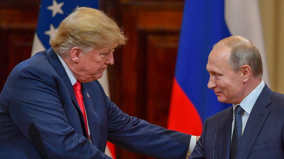 US President Donald Trump (L) and Russia's President Vladimir Putin shake hands before attending a joint press conference after a meeting at the Presidential Palace in Helsinki, on July 16, 2018.