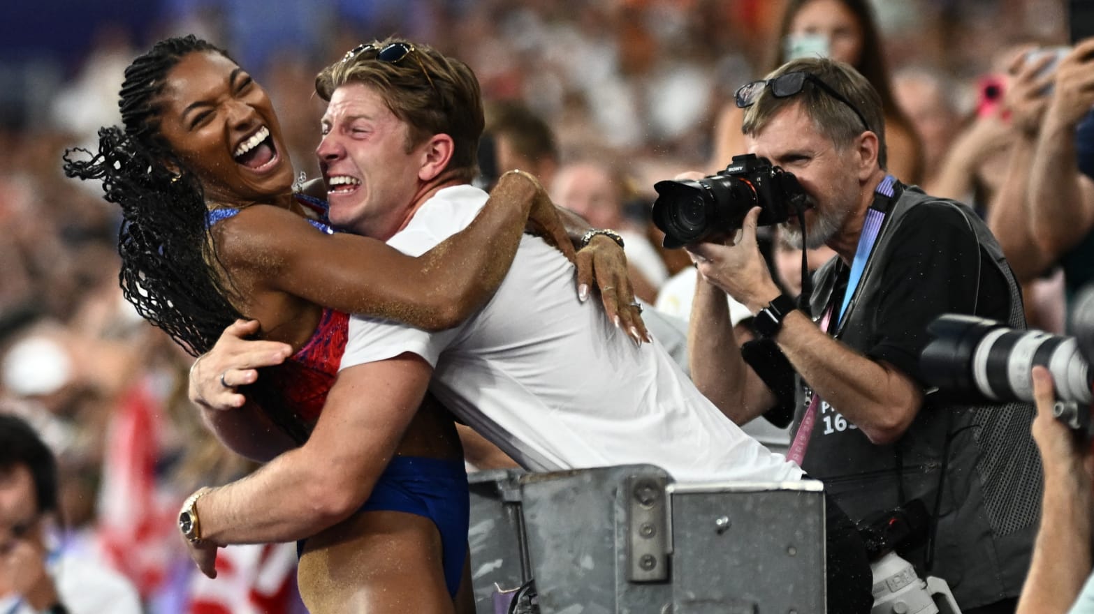 Tara Davis-Woodhall celebrates with her husband Hunter Woodhall after winning gold.