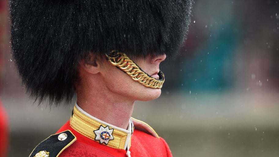 A soldier from The Coldstream Guards waits for Britain's Queen Elizabeth II to return to Buckingham Palace from the Houses of Parliament in central London