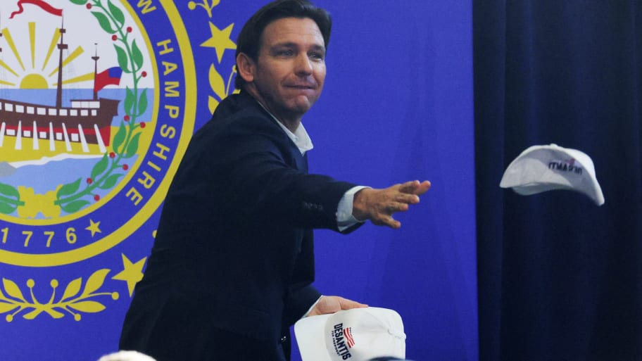 Republican presidential candidate and Florida Gov. Ron DeSantis throws campaign hats into the crowd at a campaign event in Manchester, New Hampshire, June 1, 2023.