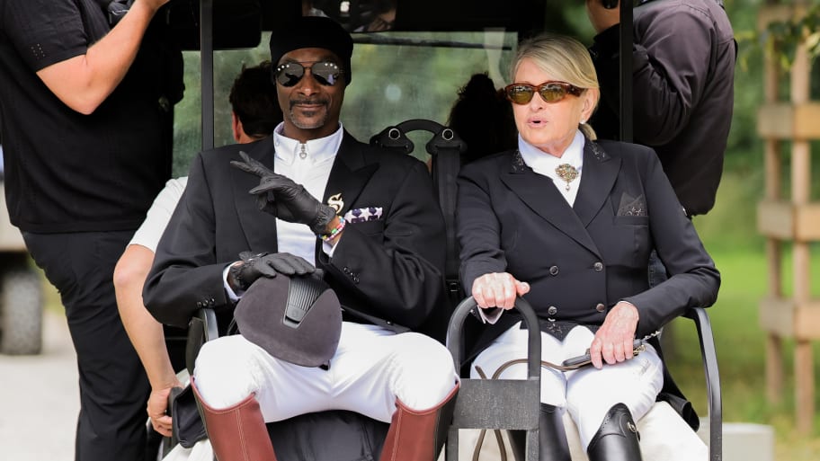 Snoop Dogg and Martha Stewart ride in a golf cart during the Grand Prix Special at the Paris Olympics. 