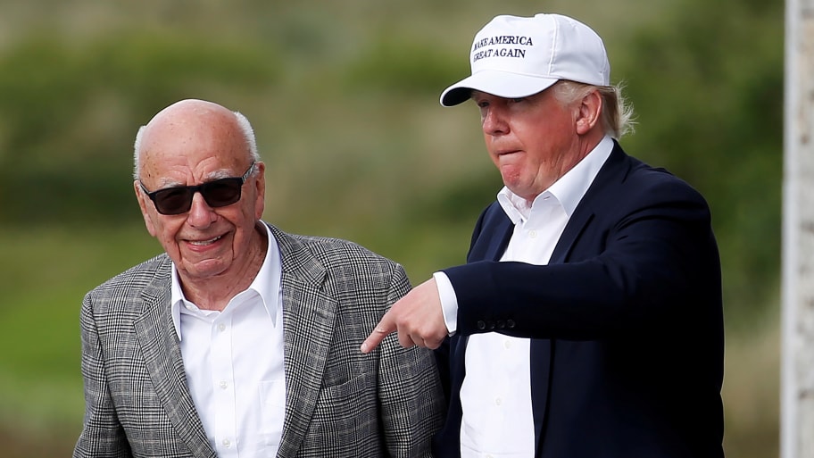 Donald Trump speaks to media mogul Rupert Murdoch as they walk out of Trump International Golf Links in Aberdeen, Scotland, June 25, 2016. 