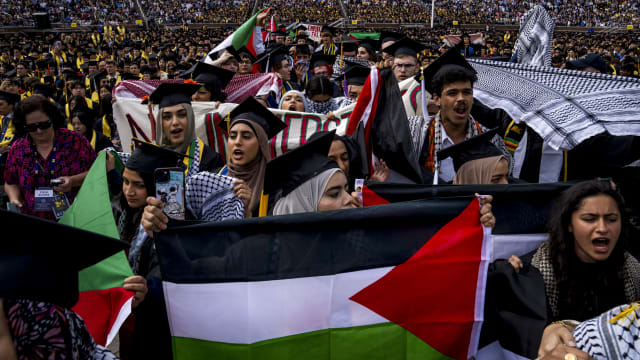 Students demonstrate during a Pro-Palestinian protest during the University of Michigan's spring commencement ceremony on May 4, 2024 at Michigan Stadium in Ann Arbor, Michigan.