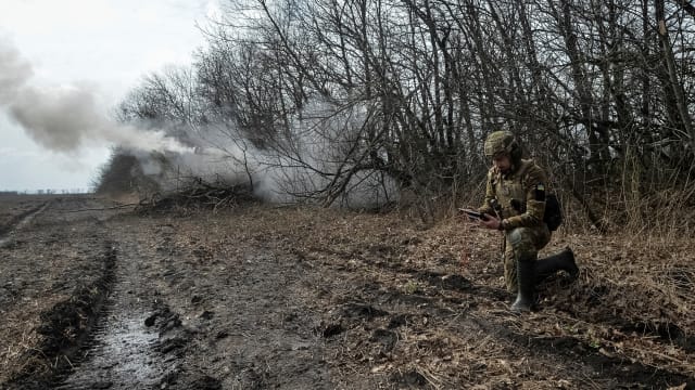 Ukrainian servicemen fire towards Russian troops near the front line city of Bakhmut