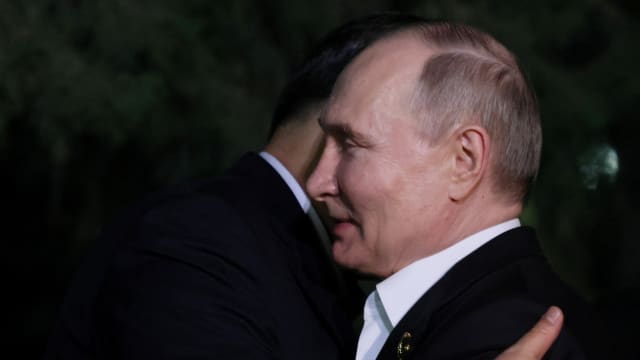 Russian President Vladimir Putin and Chinese President Xi Jinping hug
