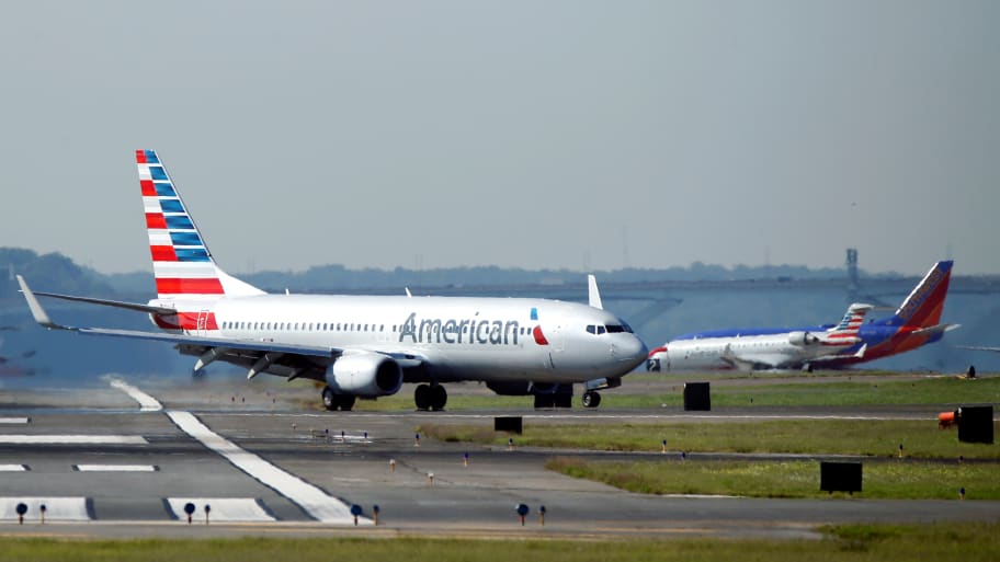 An American Airlines jet taxis on the runway.