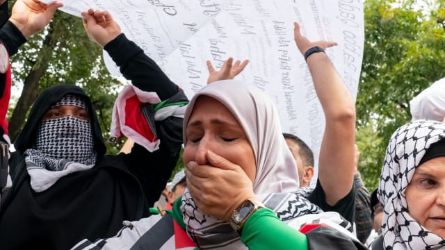 A protester weeps during a rally in support of Palestinians at the Texas State Capitol in Austin, Texas