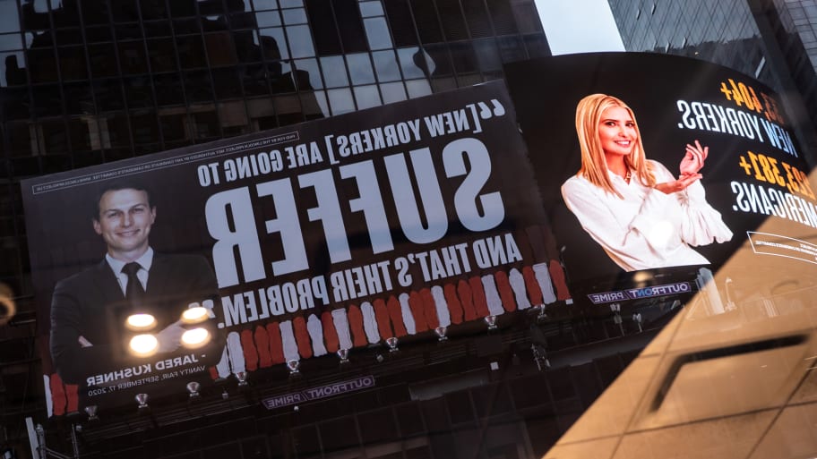 Images of Ivanka Trump and Jared Kushner are reflected on a window alongside messages about coronavirus disease (COVID-19) infections and deaths on billboards sponsored by The Lincoln Project above Times Square in New York City.