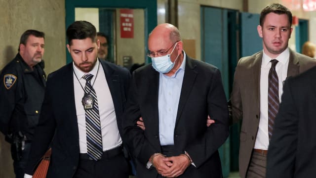 Trump Organization's former Chief Financial Officer Allen Weisselberg walks handcuffed at Manhattan Criminal Court.