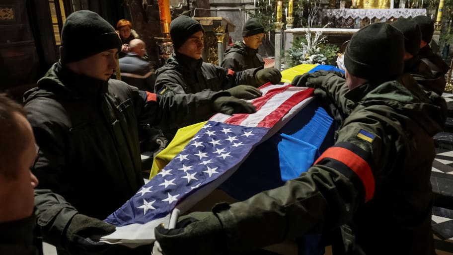 Ukrainian servicemen cover former U.S. Navy SEAL and Ukrainian international legion serviceman Daniel Swift's coffin with American and Ukrainian flags, during a memorial ceremony in Lviv, Ukraine January 31, 2023. 