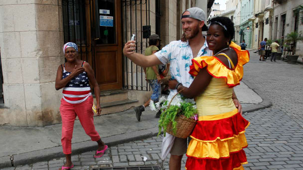 An American tourist (2nd R) takes a selfie in Havana, Cuba, September 29, 2017.