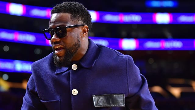 Kevin Hart walks courtside as he attends a basketball game in Los Angeles.