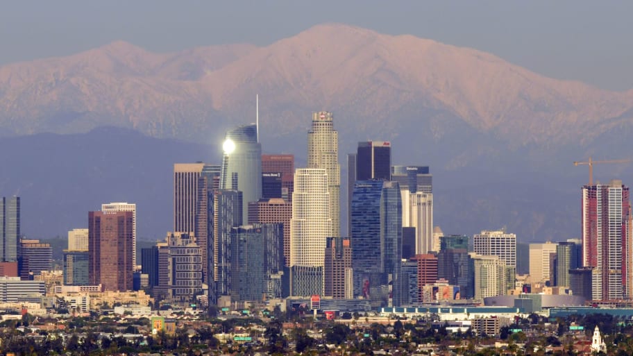 This photo taken on February 7, 2019 shows a view of the downtown Los Angeles skyline with the snow-covered San Gabriel Mountains in the background.