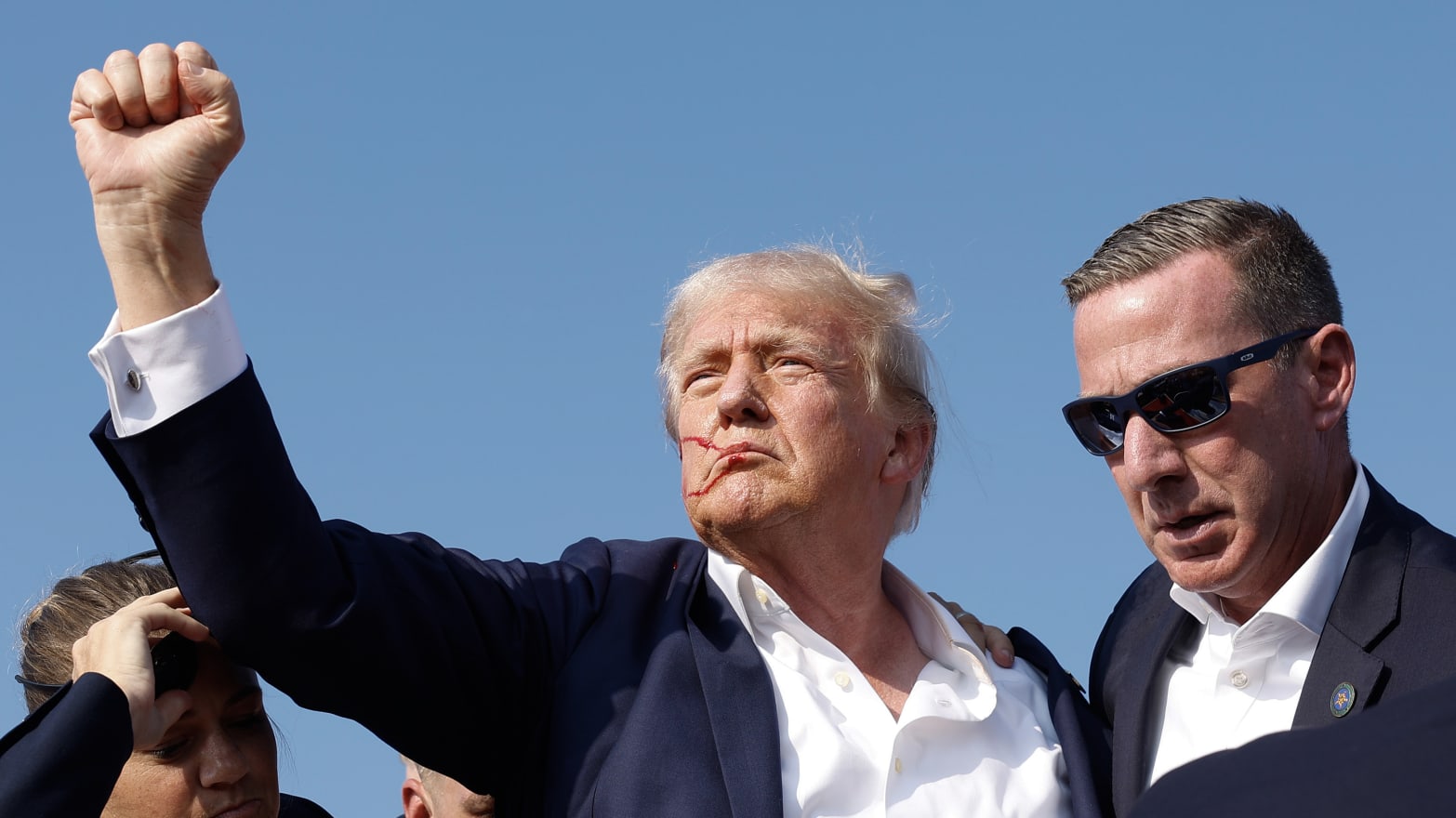 Trump raises fist to the crowd after getting shot at a rally