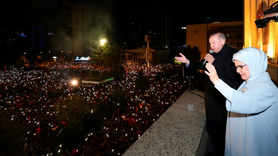 Turkish President Tayyip Erdogan, accompanied by his wife, Emine Erdogan, addresses his supporters at the AK Party headquarters in Ankara, Turkey, May 15, 2023. 
