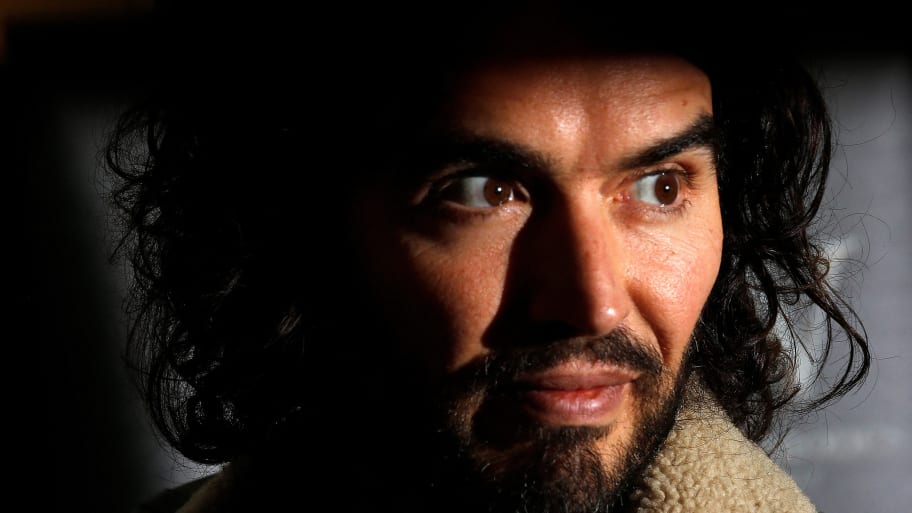 Comedian Russell Brand poses for photographers before signing copies of his new book in 2014.
