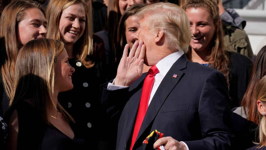 Donald Trump whispers to Maryland women’s lacrosse team members as he greets members of Championship NCAA teams at the White House in Washington, D.C., Nov. 17, 2017.  