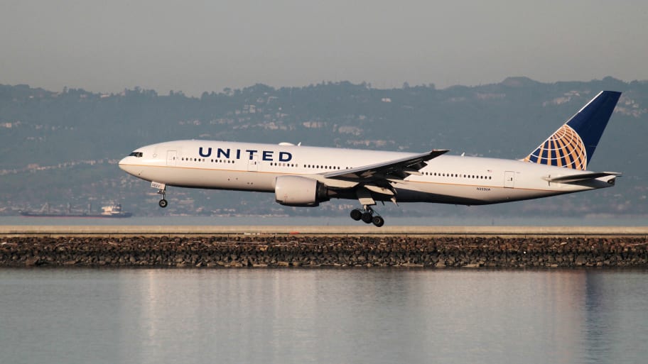 A United Airlines Boeing 777-200 lands at San Francisco International Airport, San Francisco, California.