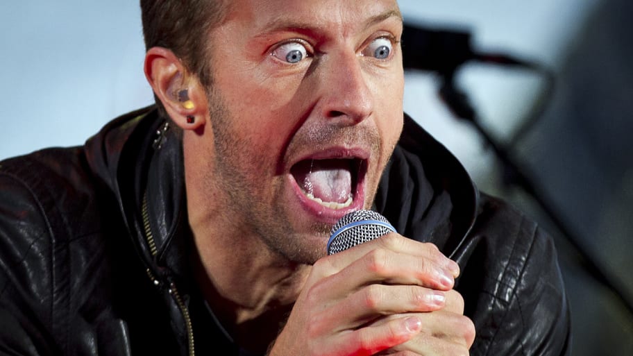 Chris Martin performs with U2 during a surprise concert in support of World AIDS Day in Times Square in New York, December 1, 2014.  
