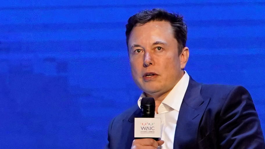 Elon Musk speaks into a microphone.