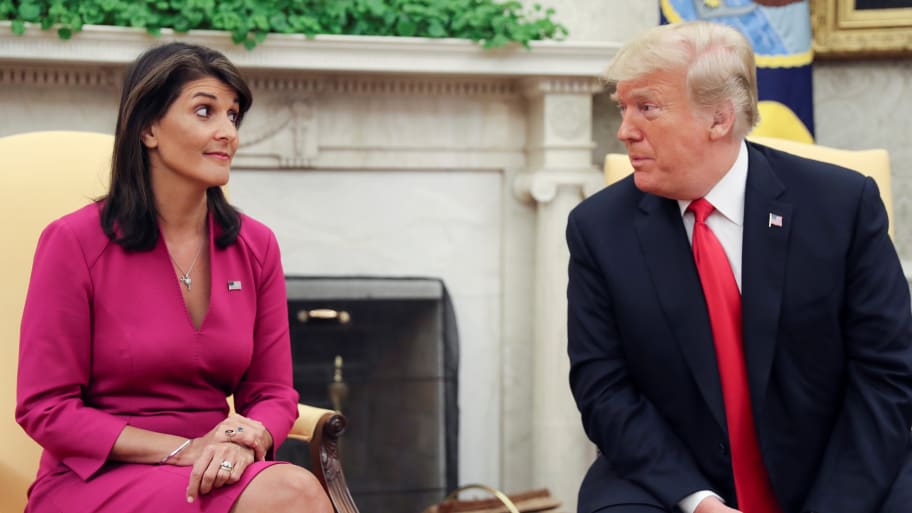 U.S. President Donald Trump talks with U.N. Ambassador Nikki Haley in the Oval Office of the White House.