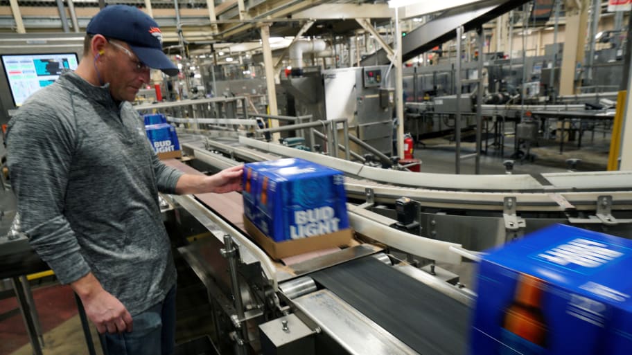 Gene Bocis, general manager for the Anheuser-Busch brewery watches cases of Bud Light beer move down a conveyor belt in Fort Collins, Colorado.