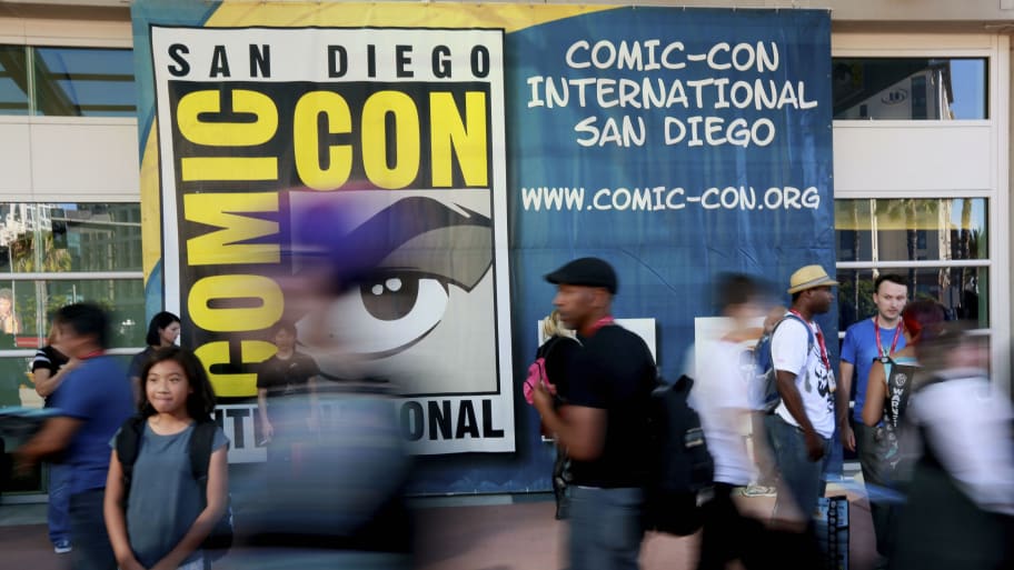 Attendees walk outside the Convention Center during the 2014 Comic-Con International Convention. A slew of studios and productions have canceled their panels at the upcoming 2023 San Diego Comic-Con now that the Screen Actors Guild is on strike.