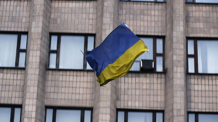 A Ukrainian flag falls after it was thrown by pro-Russia protesters from the top of the district council building in Donetsk, eastern Ukraine, May 4, 2014. 