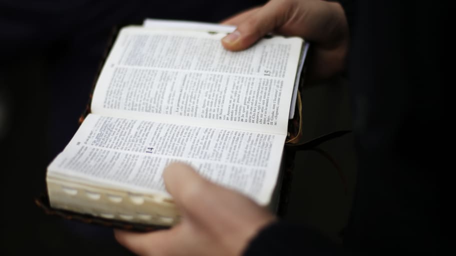 A man holding an open bible