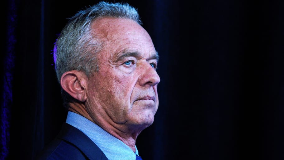 Robert Kennedy, Jr. stands wearing suit and tie