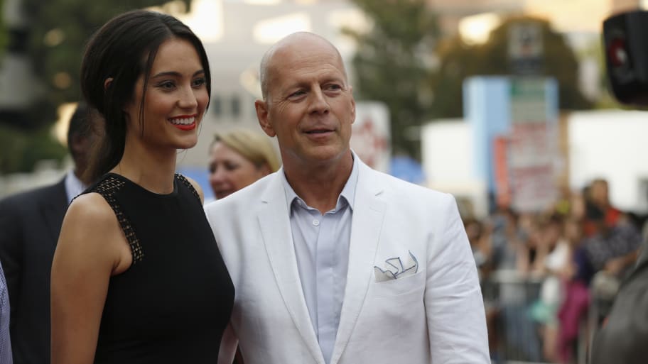 Bruce Willis and his wife Emma Heming pose at the premiere of the film “Red 2” in Los Angeles, California July 11, 2013.