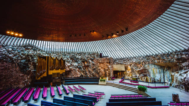 A photograph of the interior of Temppeliaukio Church in Helsinki, Finland.