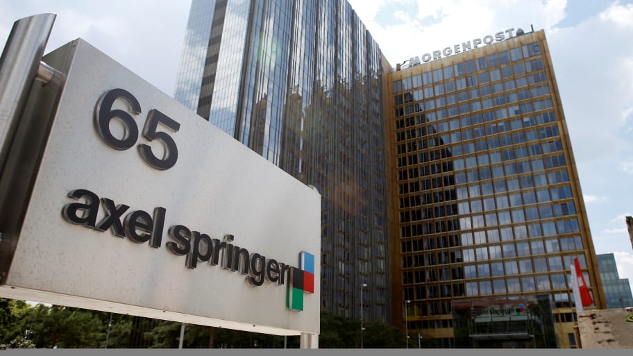 The logo of German publisher Axel Springer is pictured in front of the company’s headquarters in Berlin, July 25, 2013.