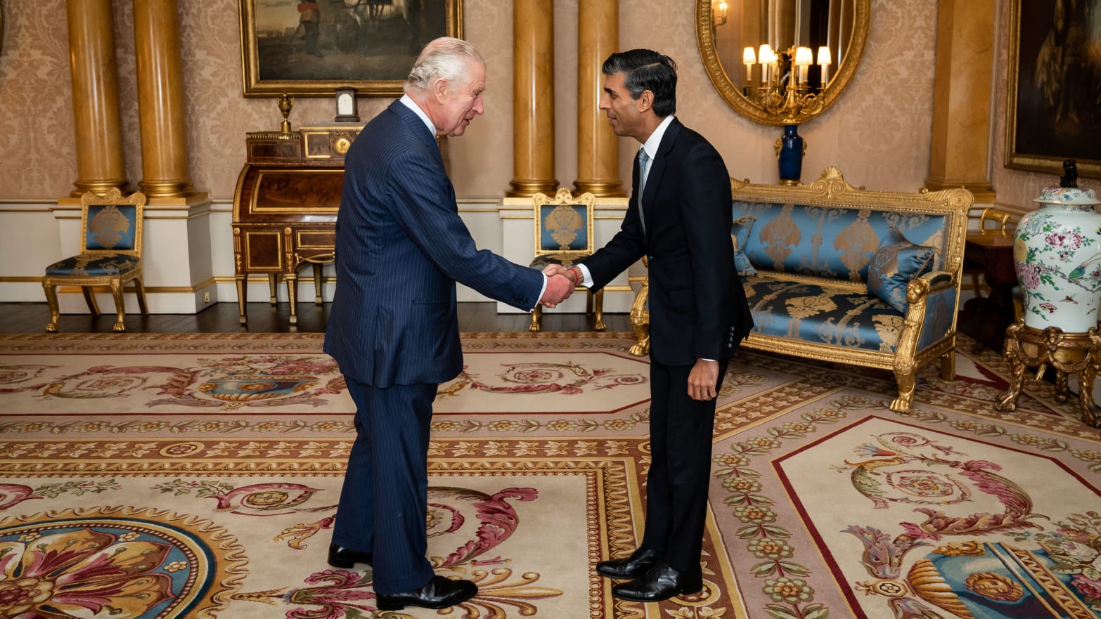 King Charles III greets newly appointed Conservative Party leader and incoming prime minister Rishi Sunak during an audience at Buckingham Palace in London on October 25, 2022